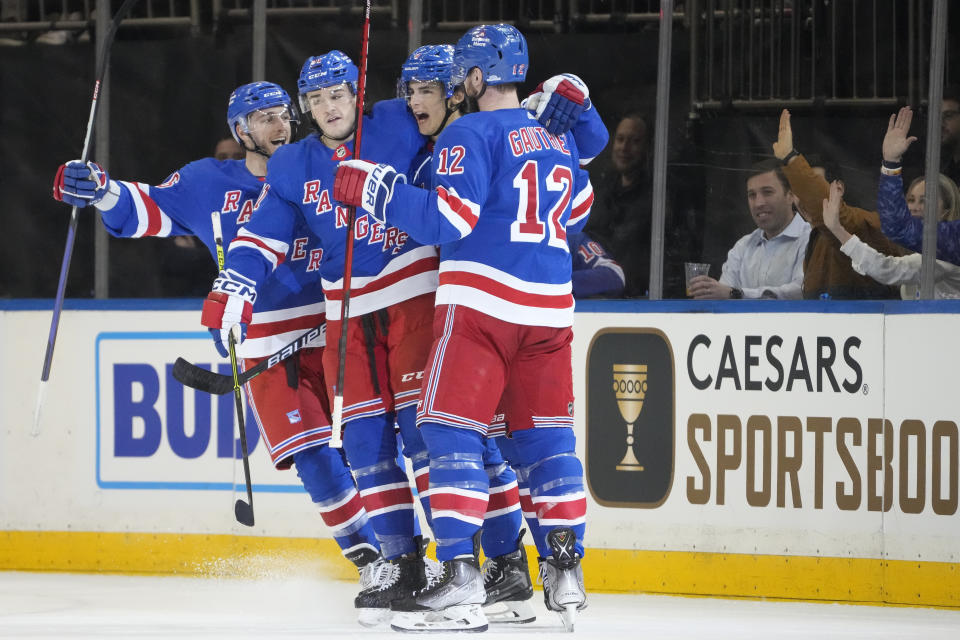 New York Rangers defenseman Braden Schneider, second from right, celebrates after scoring in the first period of an NHL hockey game against the St. Louis Blues, Monday, Dec. 5, 2022, in New York. (AP Photo/John Minchillo)