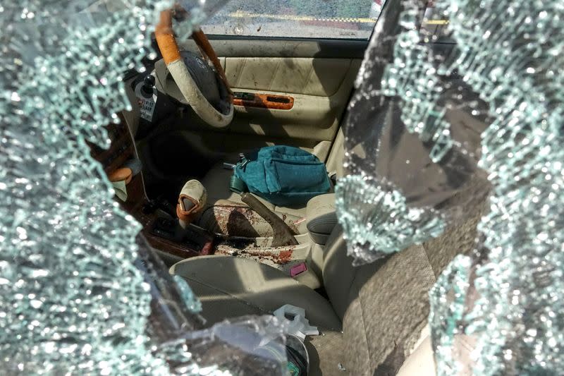 Bullet holes and blood are seen in a victim's car following a gun battle involving a Thai soldier on a shooting rampage are seen, in Nakhon Ratchasima