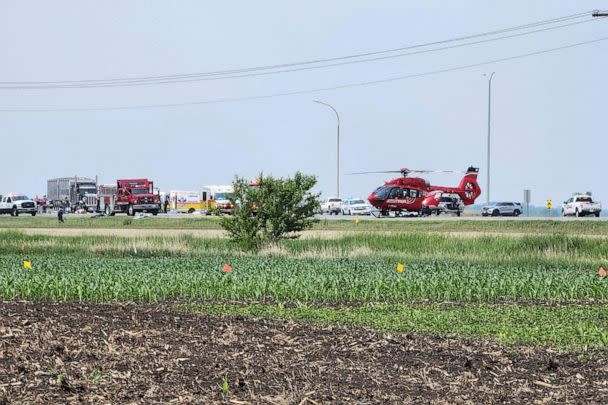 PHOTO: Smoke comes out of a car as first responders are at the scene of a deadly road accident near Carberry, west of Winnipeg, Canada, June 15, 2023. (Nirmesh Vadera/AFP via Getty Images)