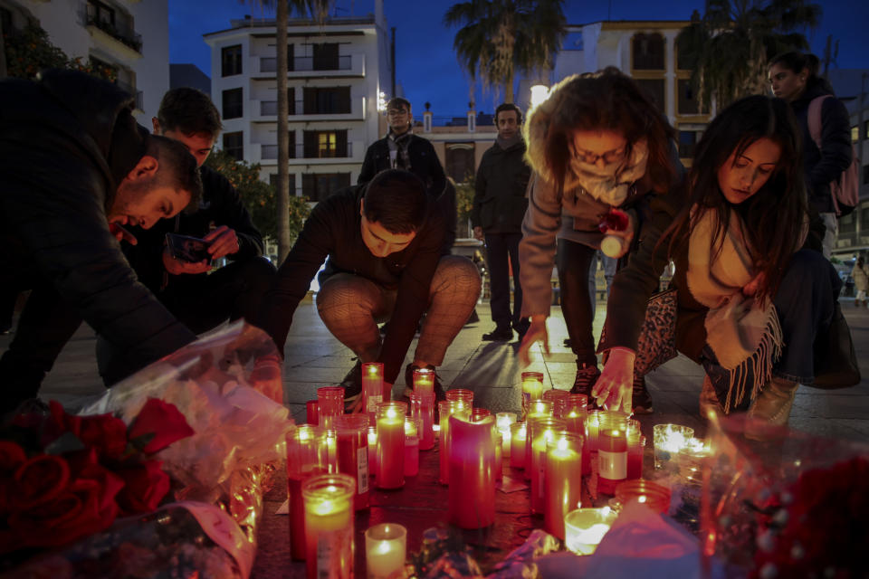 ARCHIVO - Varias personas encienden velas el 26 de enero de 2023 junto a un monumento conmemorativo en honor del sacristán de una iglesia asesinado el 25 de enero en Algeciras, en el sur de España. (AP Foto/Juan Carlos Toro)