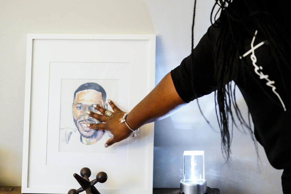 In this July 8, 2021, photo Latrice Felix whose son Alan Womack Jr. was was killed in 2020 during a fight, touches an image of him during an interview with The Associated Press in King of Prussia, Pa. (AP Photo/Matt Rourke)