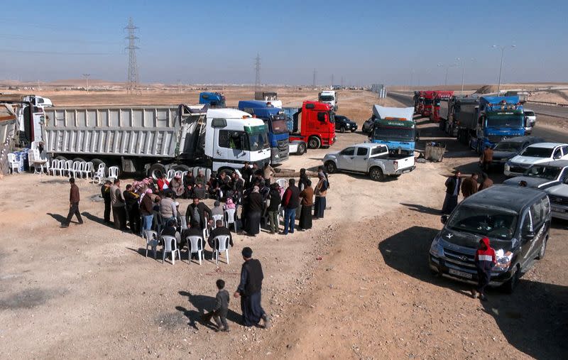 Truckers gather during a strike over fuel price rises in the southern city of Maan