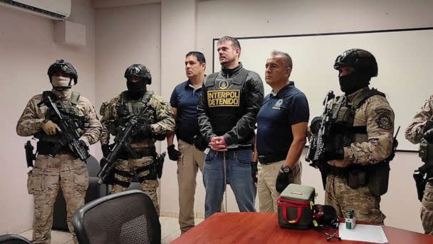 PHOTO: Dutch citizen Joran van der Sloot stands with security forces previous to his extradition to the U.S., in Lima, Peru June 8, 2023. (Interpol via Reuters)