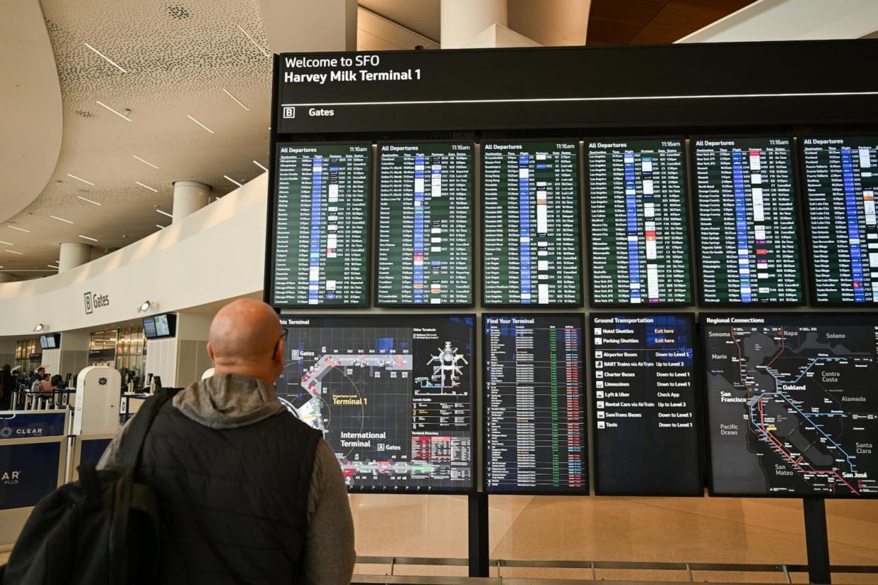 PHOTO: A man checks flight information signs at San Francisco International Airport (SFO) in San Francisco, CA, Feb. 4, 2024.  (Tayfun Coskun/Anadolu via Getty Images)
