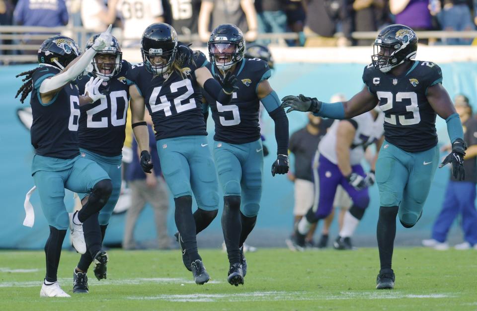 Jacksonville Jaguars cornerback Chris Claybrooks (6), safety Daniel Thomas (20), safety Andrew Wingard (42), safety Andre Cisco (5) and linebacker Foyesade Oluokun (23) celebrate after teammate Jacksonville Jaguars cornerback Tyson Campbell (32) recovered a fumble by Baltimore Ravens running back Gus Edwards (35) with just under 5 minutes to play int he fourth quarter. The Jacksonville Jaguars hosted the Baltimore Ravens at TIAA Bank Field in Jacksonville, FL Sunday, November 27, 2022. The Jaguars got momentum late in the game to win 28 to 27 over the Ravens. [Bob Self/Florida Times-Union]