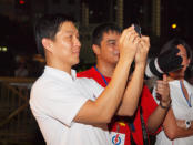 Acting manpower minister Tan Chuan-Jin is spotted at the fringes of the rally crowd. (Yahoo! photo/Alvin Ho)