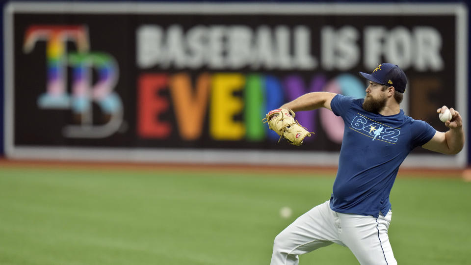 *Hold for Story* Tampa Bay Rays relief pitcher Jalen Beeks warms up near a "Baseball is for Everyone" banner on the right field wall before a game against the Minnesota Twins, Wednesday, June 7, 2023, in St. Petersburg, Fla. Almost 80 years after Jackie Robinson broke the majors’ color barrier in a landmark moment for the American civil rights movement, the dueling expressions of LGBTQ+ support and seeming rejection recalled the question of when the big leagues might welcome their first active openly gay player. (AP Photo/Chris O'Meara)