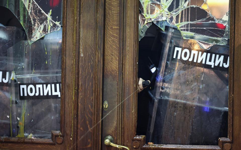 Protesters damaged the building's windows and doors