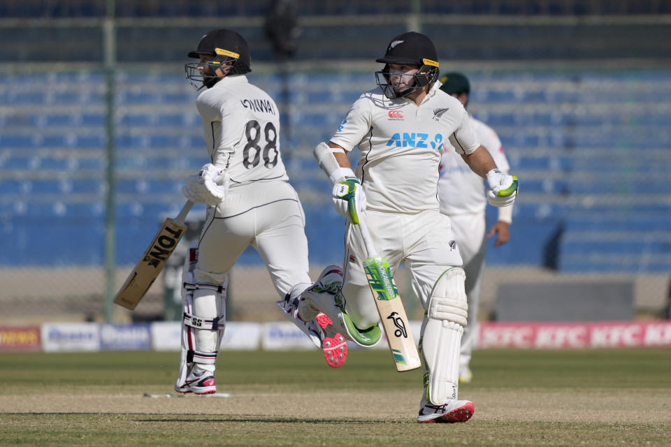 New Zealand's Tom Latham, right, and , Devon Conway take a run during the first day of the second test cricket match between Pakistan and New Zealand, in Karachi, Pakistan, Monday, Jan. 2, 2023. (AP Photo/Fareed Khan)