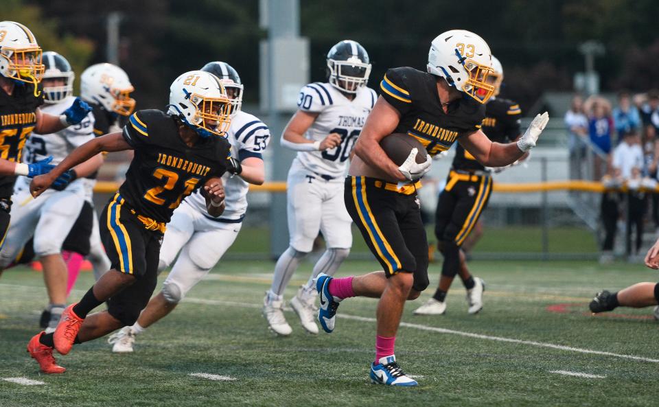 Irondequoit's Cameron Miller, right, returns the ball 99 yards for a touchdown on an attempted fake field goal by Webster Thomas during a regular season game, Thursday, Oct. 5, 2023.