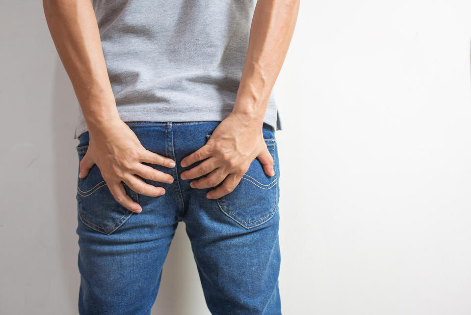 Person holding their rear end to signify a bathroom emergency