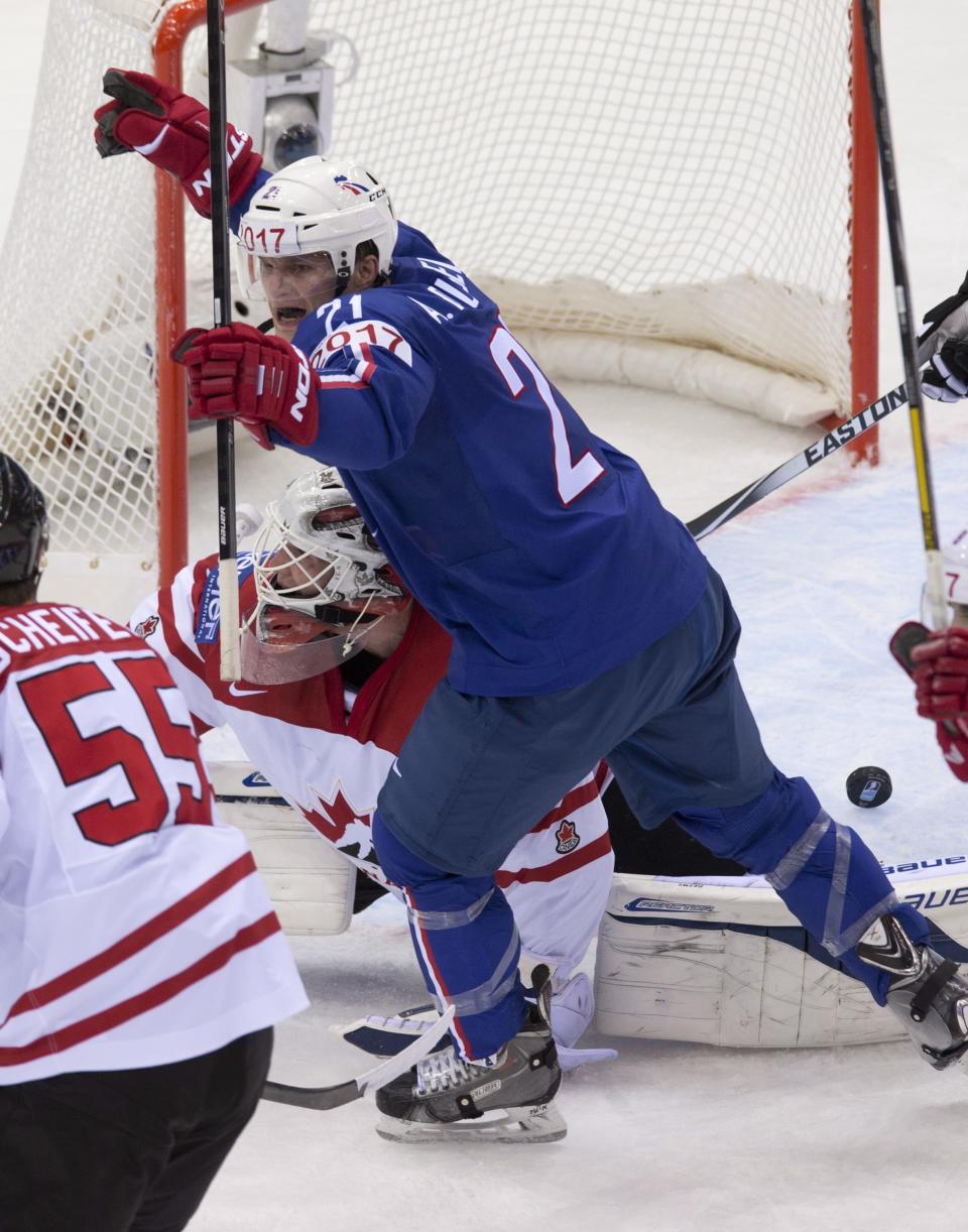 France's Antoine Roussel celebrates his team's first goal as Team Canada goalie James Reimer is down on the ice during first period action Friday, May 9, 2014 at the IIHF World Hockey Championship in Minsk Belarus. (AP Photo/The Canadian Press, Jacques Boissinot)