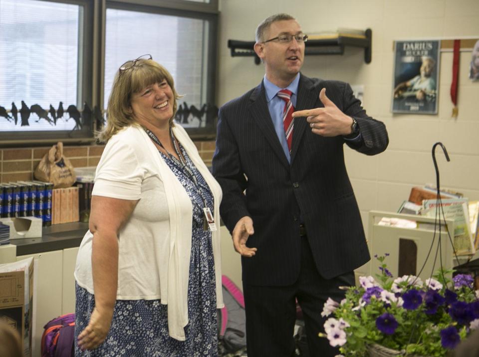 In this 2018 file photo, Assistant Superintendent Theodore Stevens announces Beth Schwitz as the Mishawaka secondary school teacher of the year.