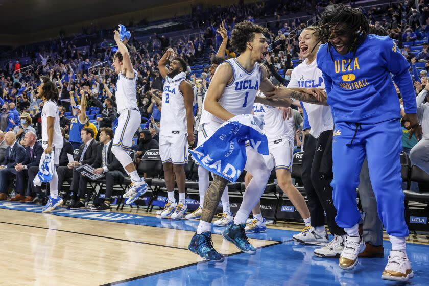 Westwood, CA, Thursday, January 27, 2022 - The UCLA bench erupts in joy after reserve UCLA Bruins guard Russell Stong (43) makes a long shot late in the game against the California Golden Bears at Pauley Pavilion. (Robert Gauthier/Los Angeles Times)
