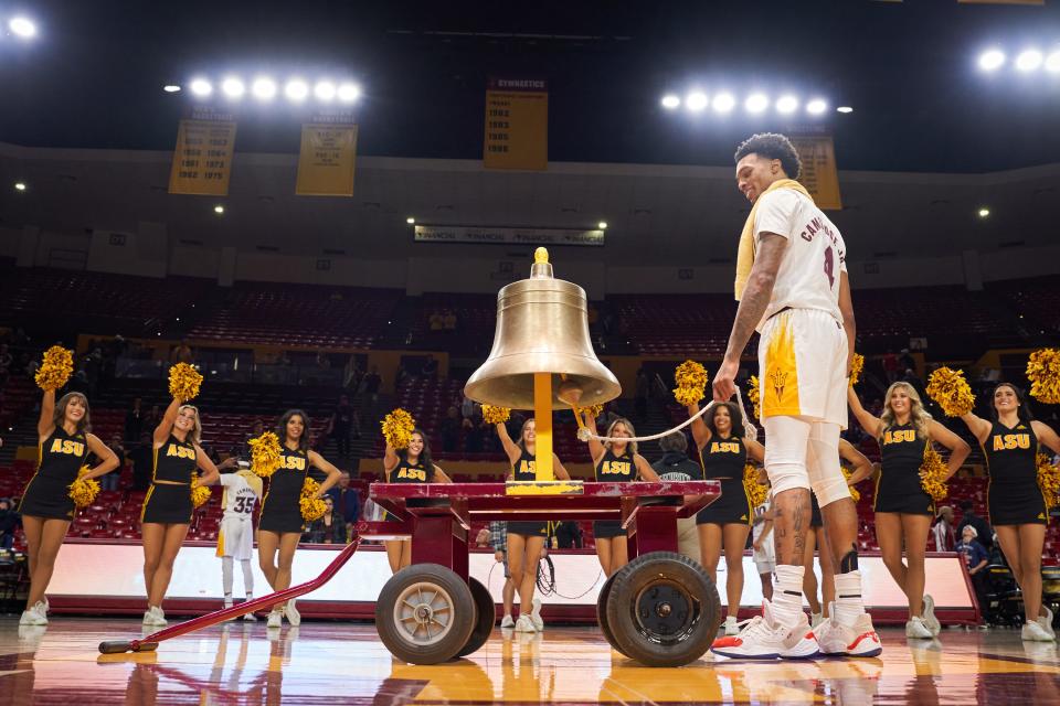 Arizona State Sun Devils fifth-year guard Desmond Cambridge Jr. (4) rings the victory bell after ASU defeated the Grambling State Tigers 80-49 at Desert Financial Arena on Tuesday, Nov. 22, 2022.