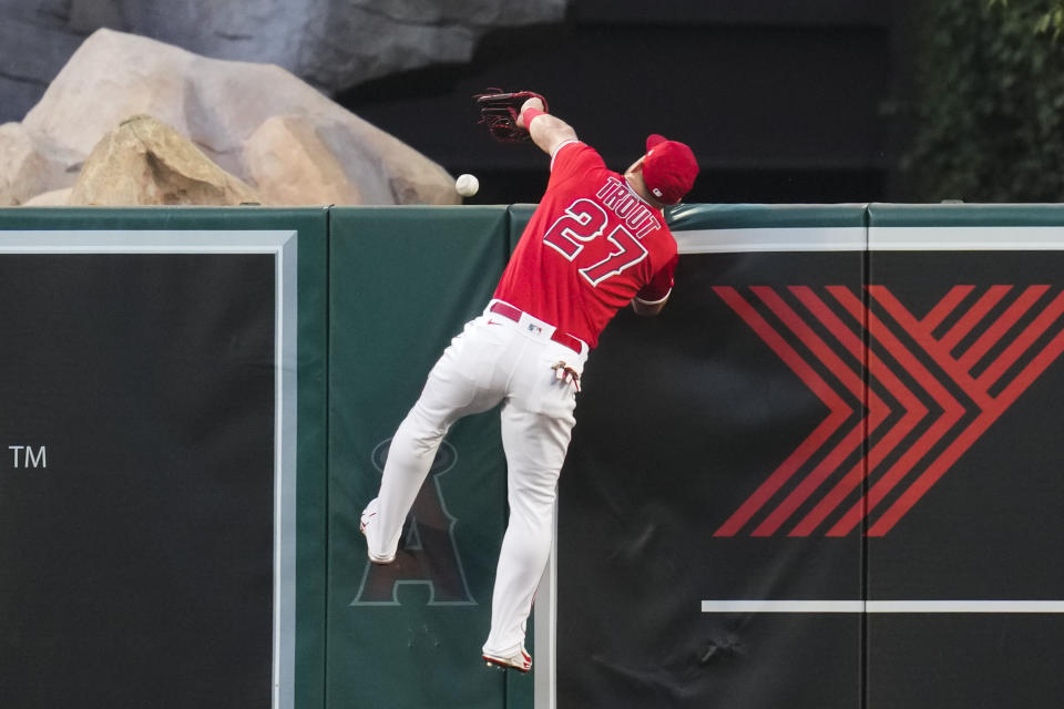 Los Angeles Angels center fielder Mike Trout (27) can't catch a home run hit by Oakland Athletics' Jesus Aguilar during the third inning of a baseball game in Anaheim, Calif., Monday, April 24, 2023. (AP Photo/Ashley Landis)
