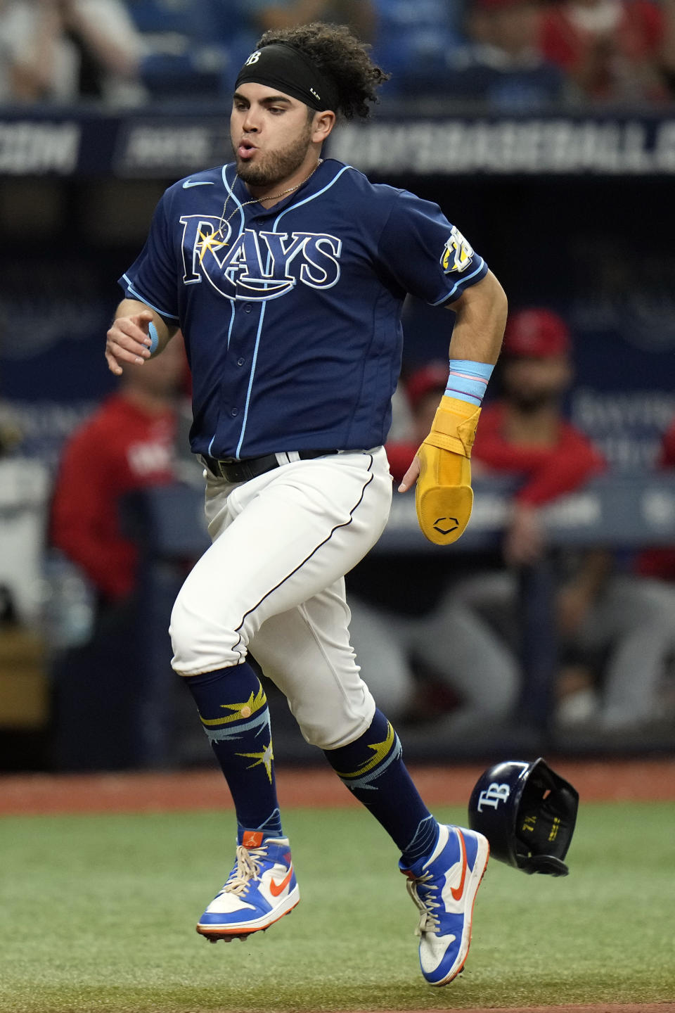 Tampa Bay Rays' Jonathan Aranda loses his helmet as he scores on a two-run double by Yandy Diaz off Los Angeles Angels relief pitcher Andrew Wantz during the sixth inning of a baseball game Wednesday, Sept. 20, 2023, in St. Petersburg, Fla. (AP Photo/Chris O'Meara)