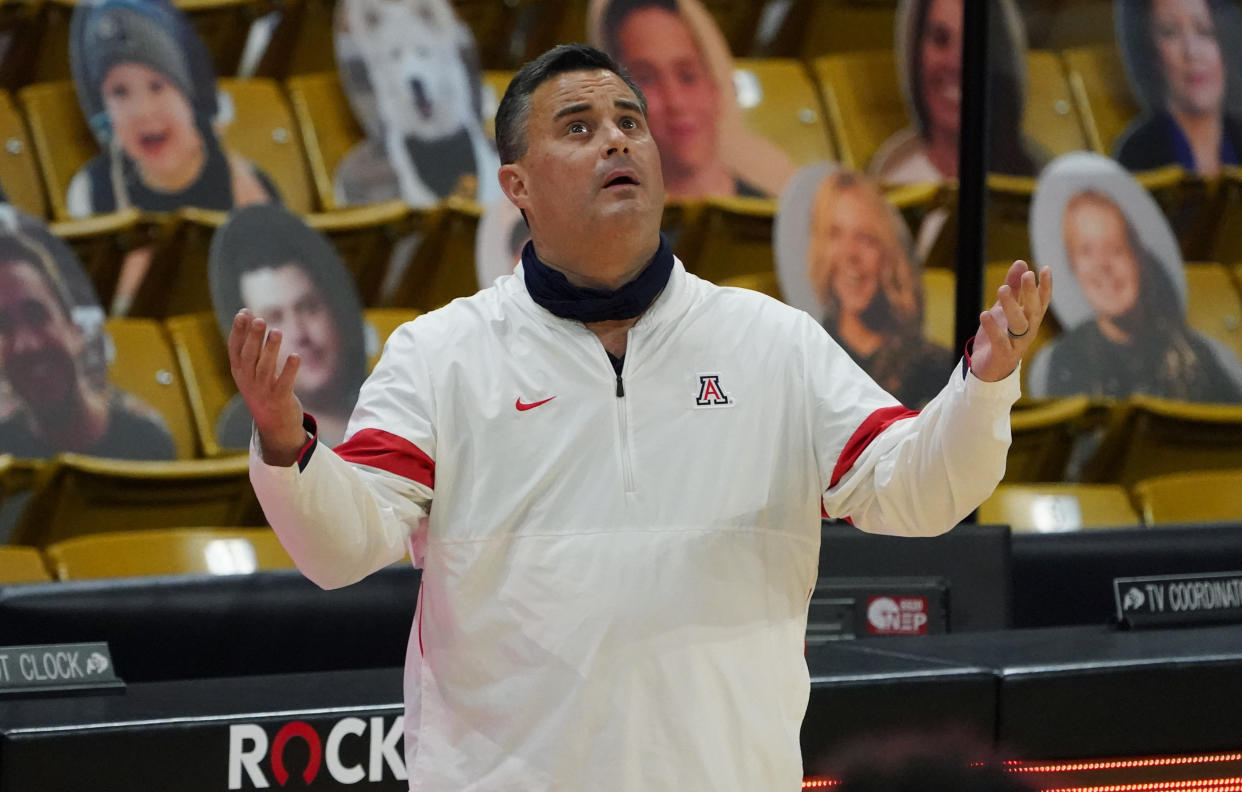 FILE - Arizona coach Sean Miller looks up at the overhead video screen to watch a foul committed by guard Bennedict Mathurin against Colorado forward Evan Battey late in the second half of an NCAA college basketball game in Boulder, Colo., in this Saturday, Feb. 6, 2021, file photo. Arizona has parted ways with men's basketball coach Sean Miller as the program awaits its fate in an NCAA infractions investigation, a person with knowledge of the situation told The Associated Press. The person told the AP on condition of anonymity Wednesday, April 7, 2021, because no official announcement has been made.( (AP Photo/David Zalubowski, File)