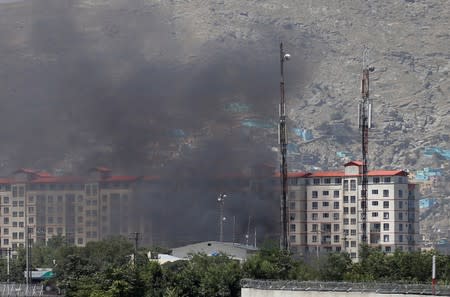Smoke rises from the site of a blast and gunfire in Kabul