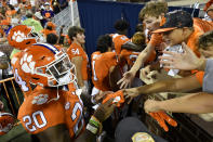 FILE - Clemson running back Kobe Pace (20) greets young fans after an NCAA college football game against South Carolina State on Saturday, Sept. 11, 2021, in Clemson, S.C. Clemson is No. 4 in The Associated Press preseason college football poll, released Monday, Aug. 15, 2022. (AP Photo/Edward M. Pio Roda, File)