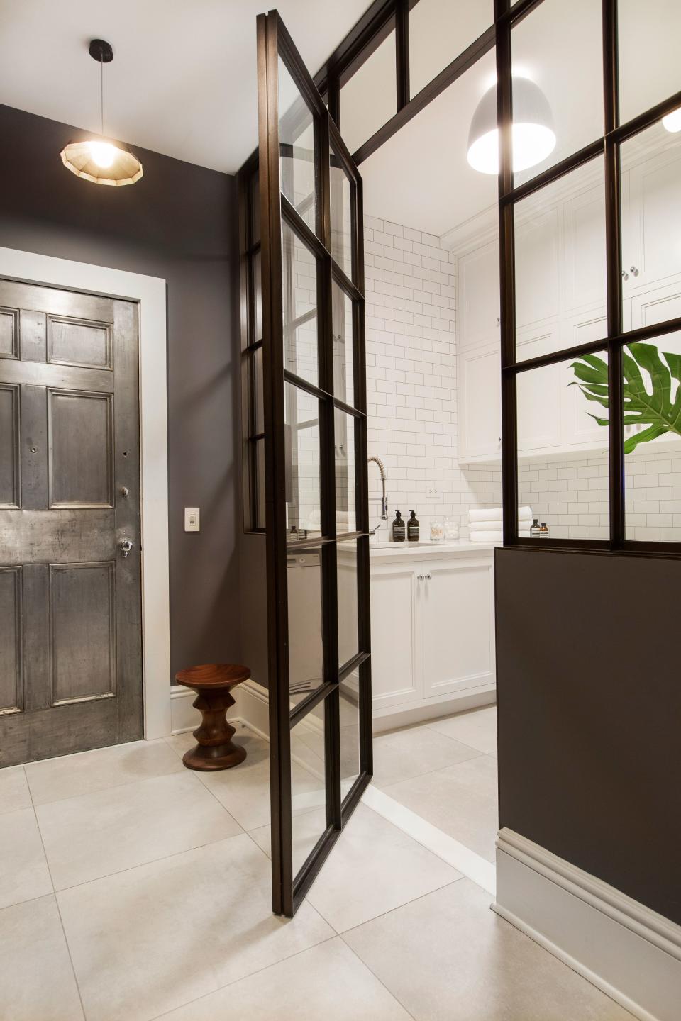 The laundry room, which is near the back entrance of the apartment, shows Grehl’s interpretation of Frank Lloyd Wright’s “compression and release” concept, where dark or narrow central areas lead to larger and brighter areas.