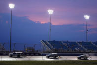 Workers dry the track at Nashville Superspeedway during a storm delay at a NASCAR Cup Series auto race Sunday, June 26, 2022, in Lebanon, Tenn. (AP Photo/Mark Humphrey)