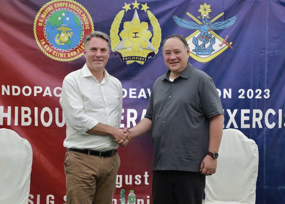 In this photo released by the Philippine DND Defense Communications Service and AFP Public Affairs Office, Australian Defence Minister Richard Marles, left, and Philippine National Defense Secretary Gilberto Teodoro Jr. pose for a photo before a large-scale combined amphibious assault exercise was conducted on Friday, Aug. 25, 2023 at a naval base in San Antonio, Zambales. Australian and Filipino forces, backed by U.S. Marines, practiced retaking an island seized by hostile forces in a large military drill Friday on the northwestern Philippine coast facing the disputed South China Sea. (Philippine DND Defense Communications Service and AFP Public Affairs Office via AP)