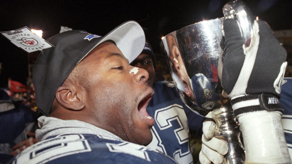Baltimore Stallions RB Mike Pringle, the 1995 CFL MVP, celebrates with the Grey Cup. (Tom Hanson/AP Photo)
