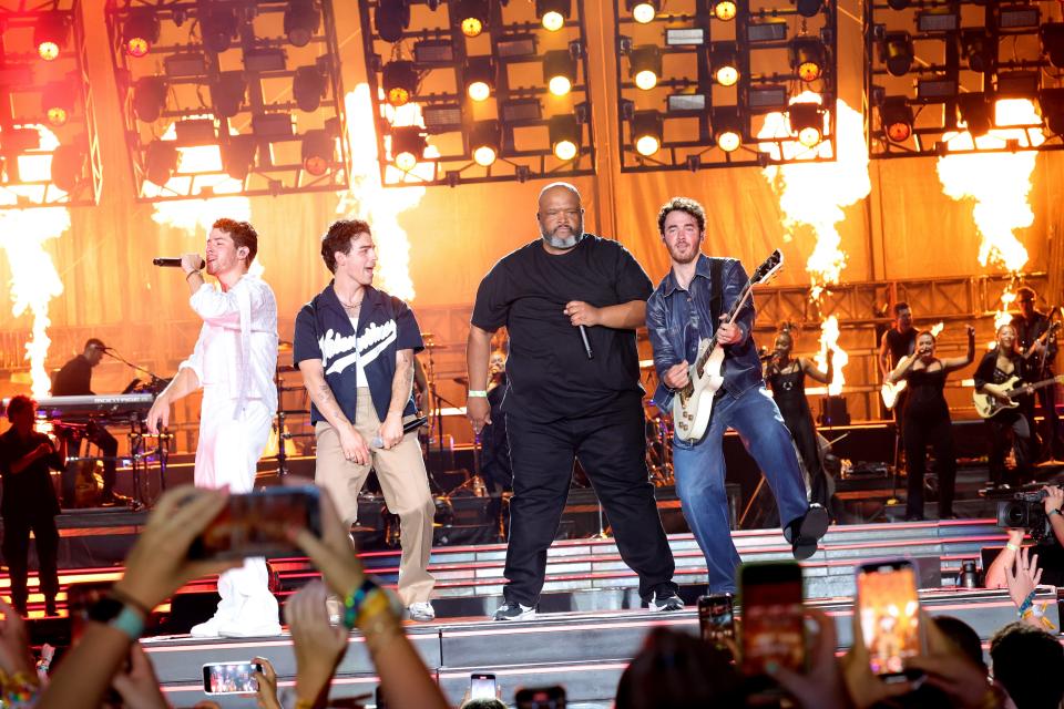 Nick Jonas, Joe Jonas, Robert "Big Rob" Feggans and Kevin Jonas perform "Burnin' Up" during The Tour opening night at Yankee Stadium on Aug. 12, 2023, in New York City.