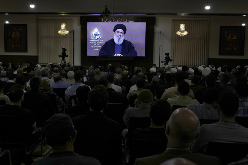 Hezbollah supporters watch a speech given by Hezbollah leader Sayyed Hassan Nasrallah on a screen during a ceremony to commemorate the death of senior Hezbollah commander Taleb Sami Abdullah, 55, who was killed last week by an Israeli strike in south Lebanon, in the southern Beirut suburb of Dahiyeh, Lebanon, Wednesday, June 19, 2024. (AP Photo/Bilal Hussein)