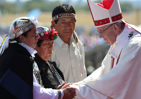 Mapuche people greet Pope Francis during a mass at the Maquehue Temuco Air Force Base in Temuco, Chile, January 17, 2018. REUTERS/Alessandro Bianchi