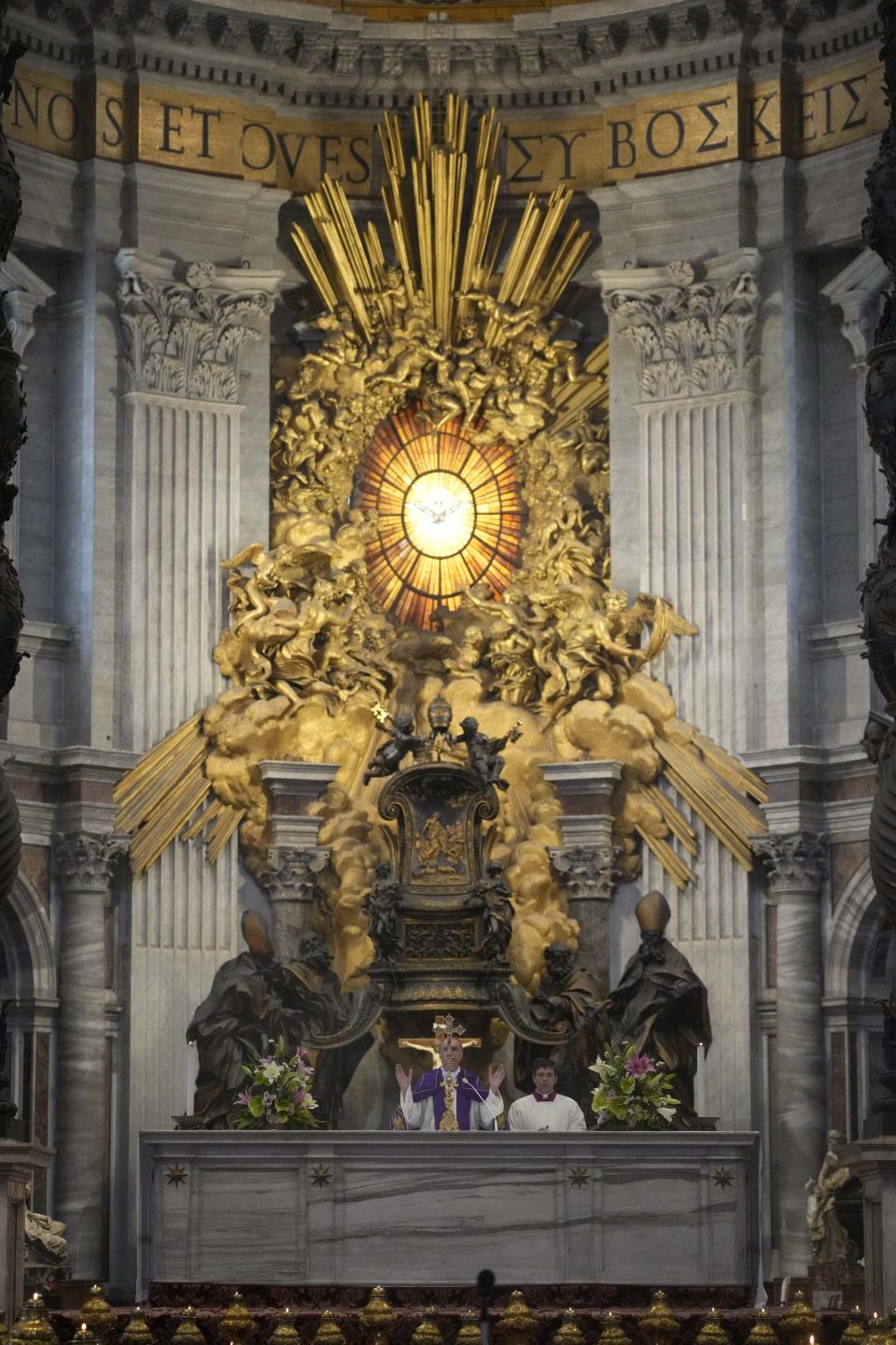 Cardinal Mauro Bassetti, center, blesses the altar of the confession during a penitential rite inside St. Peter's Basilica, Saturday, June 3, 2023. (AP Photo/Gregorio Borgia)