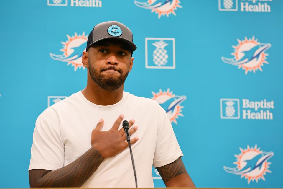 Jul 28, 2024; Miami Gardens, FL, USA; Miami Dolphins quarterback Tua Tagovailoa (1) reacts while talking to reporters during a press conference after training camp at Baptist Health Training Complex. Mandatory Credit: Sam Navarro-USA TODAY Sports