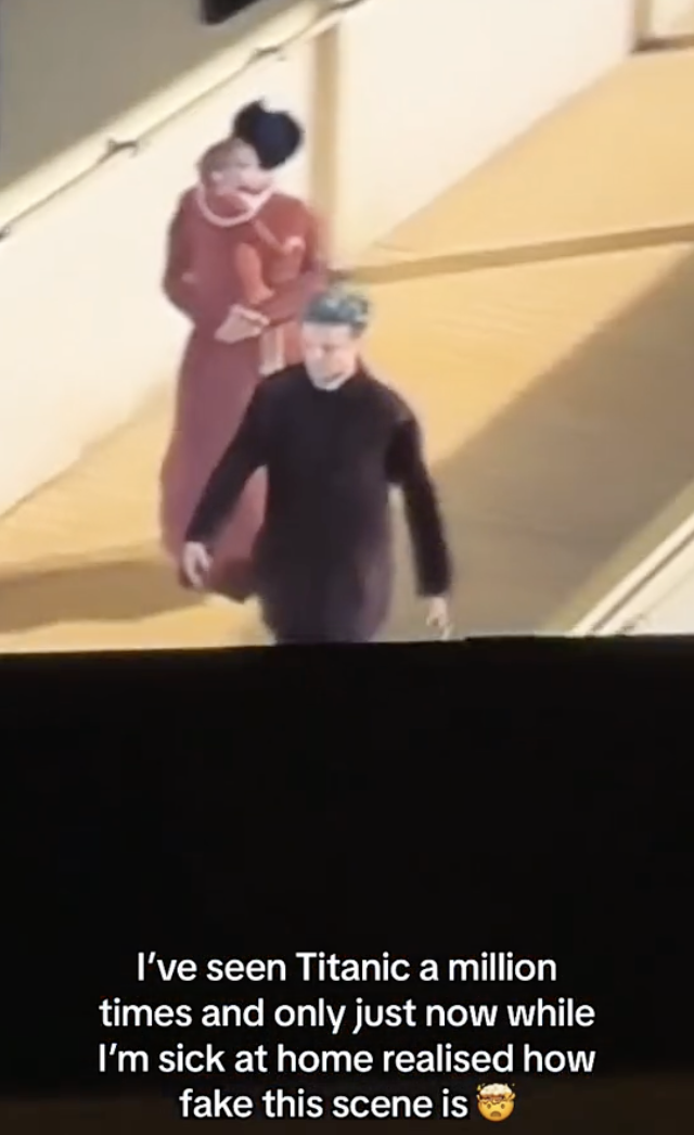 Close-up of a man, woman, and child on the deck of the Titanic who are clearly fake