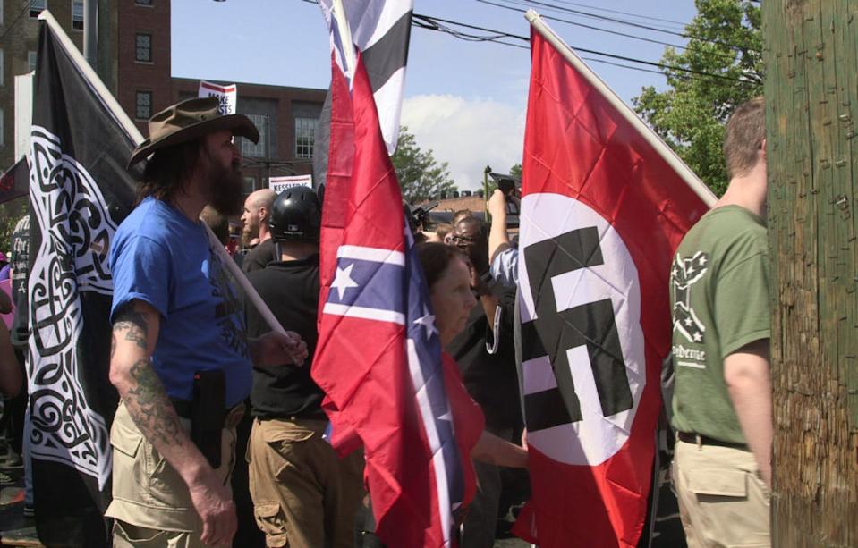 Demonstrators carry Confederate and Nazi flags during the Unite the Right rally in Charlottesville, Va., on Aug. 12, 2017. <a href="https://www.gettyimages.com/detail/news-photo/demonstrators-carry-confederate-and-nazi-flags-during-the-news-photo/830922288?adppopup=true" rel="nofollow noopener" target="_blank" data-ylk="slk:Emily Molli/NurPhoto via Getty Images;elm:context_link;itc:0;sec:content-canvas" class="link ">Emily Molli/NurPhoto via Getty Images</a>