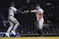 Minnesota Twins' Nick Gordon (1) and Josh Donaldson celebrate the team's 9-5 win over the Chicago Cubs after a baseball game Tuesday, Sept. 21, 2021, in Chicago. (AP Photo/Charles Rex Arbogast)