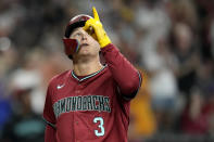 Arizona Diamondbacks designated hitter Joc Pederson points skyward as he arrives at home plate after hitting a two-run home run against the San Diego Padres during the fourth inning of a baseball game Sunday, May 5, 2024, in Phoenix. (AP Photo/Ross D. Franklin)