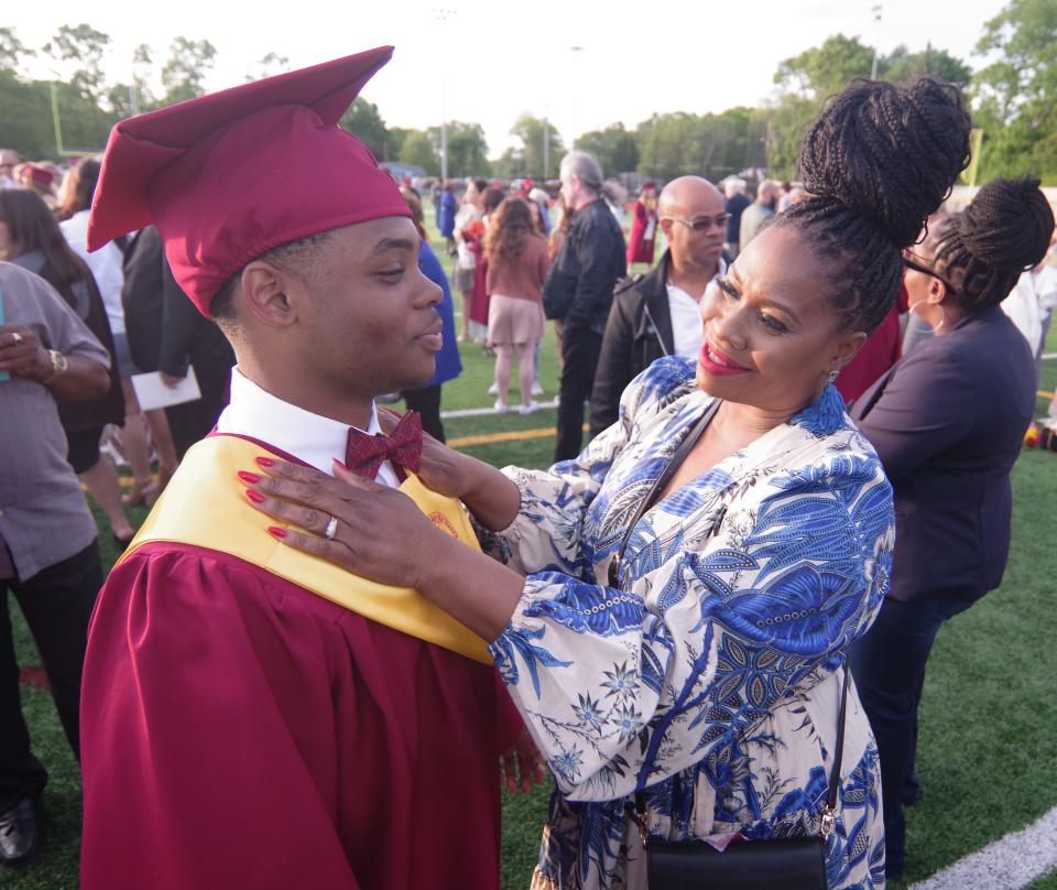 Aidan Taitt of Brockton gets a proud embrace from mom Joy-Ann in the Cardinal Spellman field after graduation came to an end on Thursday, May 26, 2022.