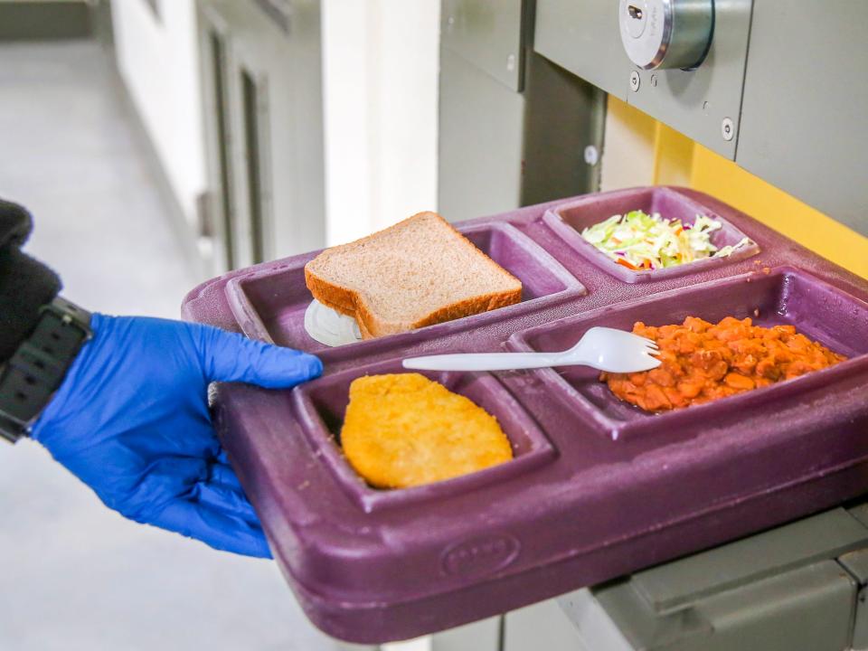 ADELANTO, CA - NOVEMBER 15: A guard serves lunch to an immigrant detainee in his 'segregation cell' during lunchtime at the Adelanto Detention Facility on November 15, 2013 in Adelanto, California. Most detainees in segregation cells are sent there for fighting with other immigrants, according to guards. The facility, the largest and newest Immigration and Customs Enforcement (ICE), detention center in California, houses an average of 1,100 immigrants in custody pending a decision in their immigration cases or awaiting deportation. The average stay for a detainee is 29 days. The facility is managed by the private GEO Group. ICE detains an average of 33,000 undocumented immigrants in more than 400 facilities nationwide. (Photo by John Moore/Getty Images)