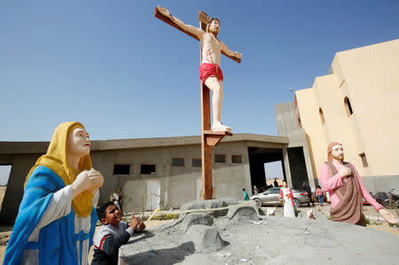 A Christian boy who left with his family from Al-Arish city North Sinai’s Governorate capital after the escalation of a campaign targeting Christians by Islamic State militants last week, looks at scale model of Christ after arriving at the Saint Church in Ismailia, northeast of Cairo, Egypt February 27, 2017. Picture taken February 27, 2017. REUTERS/Amr Abdallah Dalsh