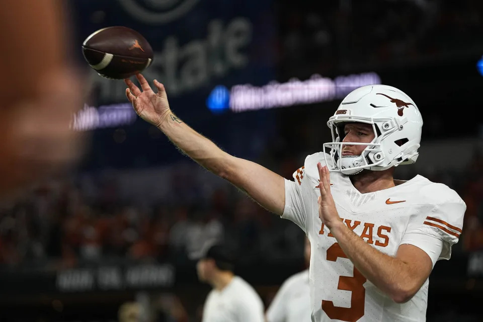 Texas Longhorns quarterback <a class="link " href="https://sports.yahoo.com/ncaaf/players/329235/" data-i13n="sec:content-canvas;subsec:anchor_text;elm:context_link" data-ylk="slk:Quinn Ewers;sec:content-canvas;subsec:anchor_text;elm:context_link;itc:0">Quinn Ewers</a> (3) warms up ahead of the Big 12 Championship game against the Oklahoma State Cowboys at AT&T stadium on Saturday, Dec. 2, 2023 in Arlington.