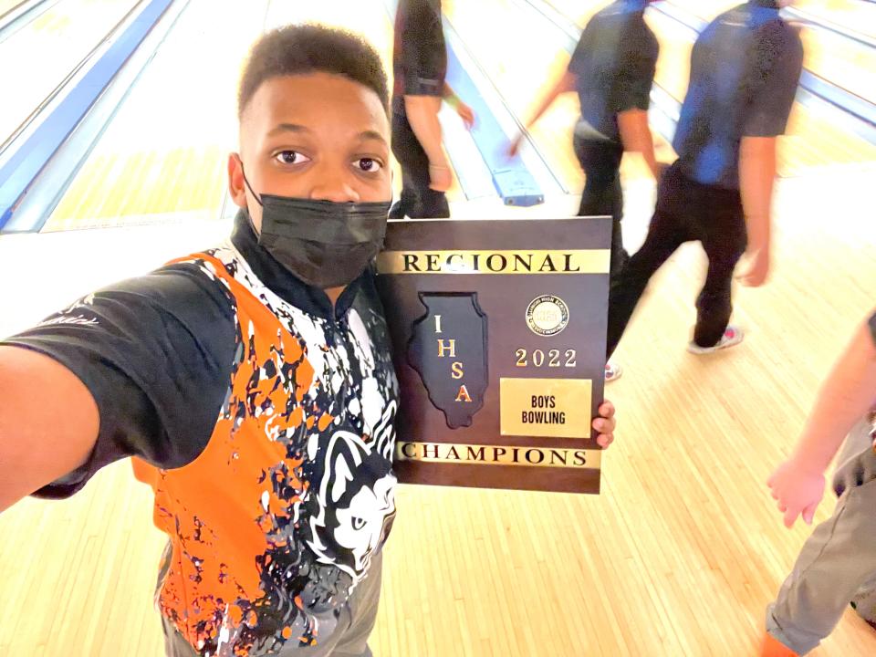 Jermarrion Simmons poses with the regional championship plaque after sparking Harlem to the team title by winning the individual title on Saturday, Jan. 15, 2022, in Rockford.