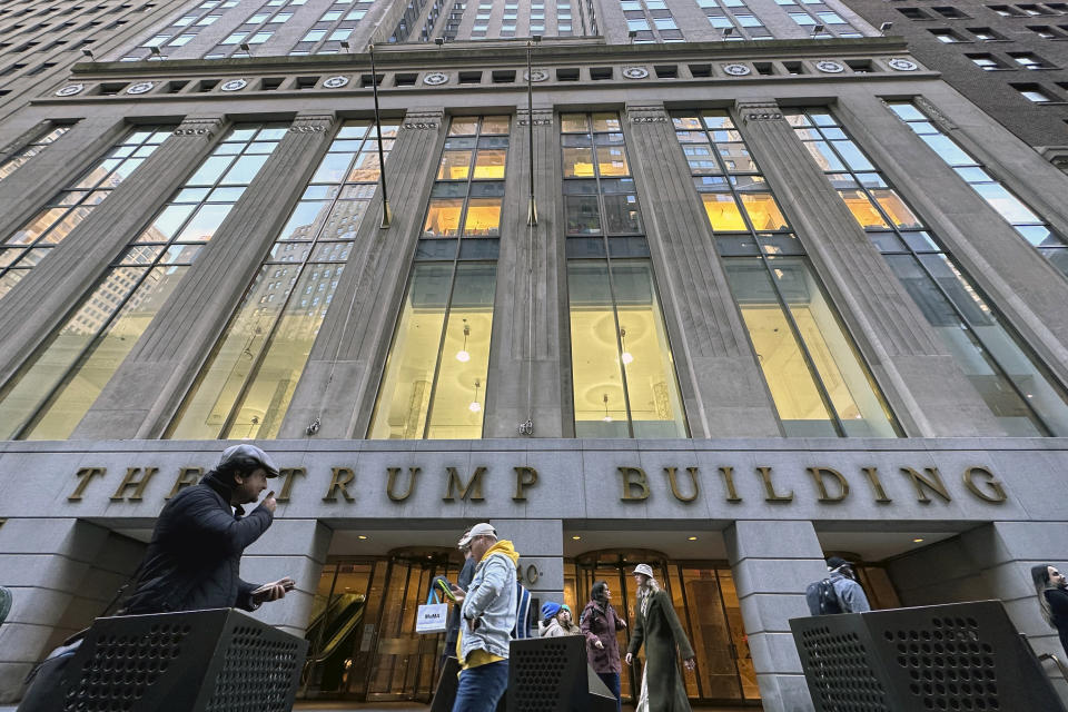 FILE - People walk by The Trump Building office building at 40 Wall Street in New York City, Friday, Nov. 3, 2023. Within days, Donald Trump could potentially have his sprawling real estate business empire ordered “dissolved” for repeated misrepresentations on financial statements to lenders, adding him to a short list of scam marketers, con artists and others who have been hit with the ultimate punishment for violating New York’s powerful anti-fraud law. An Associated Press analysis of nearly 70 years of civil cases under the law showed that such a penalty has only been imposed a dozen previous times. (AP Photo/Ted Shaffrey, File)