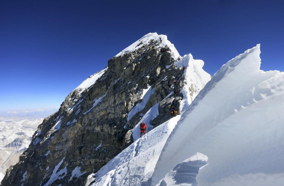 In this May 18, 2013 photo released by mountain guide Adrian Ballinger of Alpenglow Expeditions, climbers navigate the knife-edge ridge just below the Hillary Step on their way to the summit of Mount Everest, in the Khumbu region of the Nepal Himalayas. Guy Cotter was so concerned about the safety of Sherpa guides and porters through Mount Everest’s notorious Khumbu Icefall that he and another commercial guide operator hatched a plan: Before this year’s climbing season began, they would use helicopters to transport four tons of equipment above the icefall. Nepal-based Simrik Air backed the plan and hired New Zealand pilot Jason Laing, an expert in hauling loads using long cables. But in January, the answer came back from Nepalese authorities: permit denied. Three months later, Laing put his expertise to use. But not hauling gear. On April 18 came Everest’s worst disaster, in which 16 Sherpas were killed in an avalanche at the icefall. Laing made flight after flight that day, using his long cables to rescue four injured Sherpas and haul out 13 bodies. (AP Photo/Alpenglow Expeditions, Adrian Ballinger) MANDATORY CREDIT, EDITORIAL USE ONLY