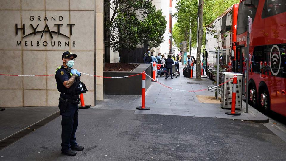 A policeman, pictured here keeping watch as tennis players, coaches and officials arrive at a hotel in Melbourne.