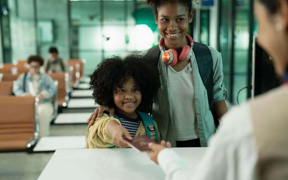 female and child tourist buys a plane ticket to travel.