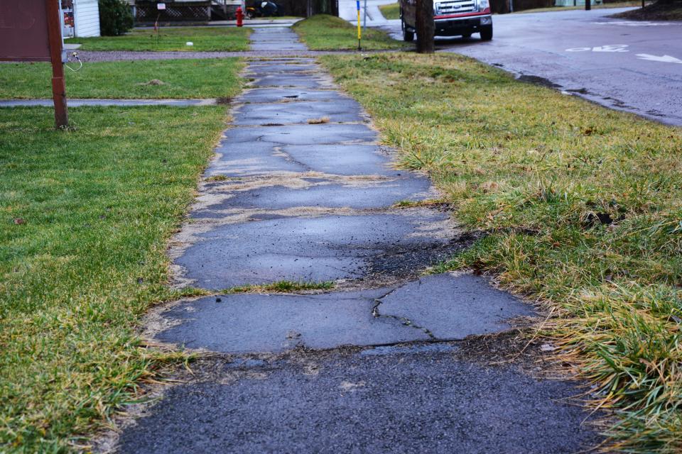 The sidewalks along Walker Street in Garrett show much wear and tear.