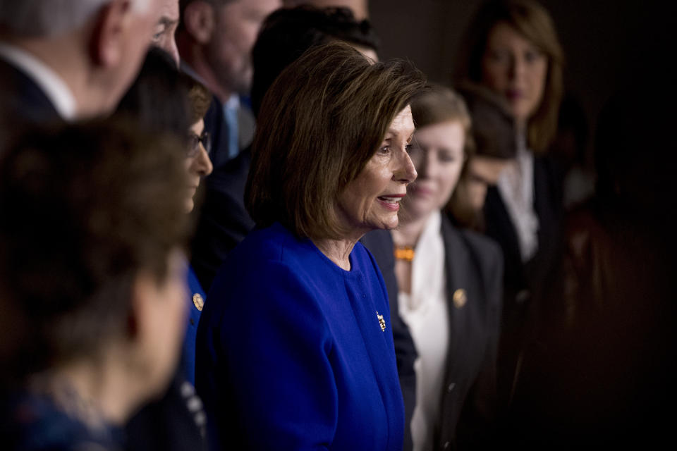 House Speaker Nancy Pelosi of Calif., accompanied by House Congress members, speaks at a news conference to discuss the United States Mexico Canada Agreement (USMCA) trade agreement, Tuesday, Dec. 10, 2019, on Capitol Hill in Washington. (AP Photo/Andrew Harnik)