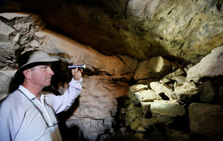 FILE PHOTO: Geologist Leonard Karr uses a flashlight inside an old abandoned mine in the Eastern Desert near the southern province of Luxor,Egypt May 20, 2016. Picture taken May 20, 2016. REUTERS/Amr Abdallah Dalsh/File Photo