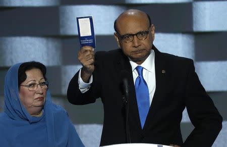 Khizr Khan, whose son, Humayun S. M. Khan was one of 14 American Muslims who died serving in the U.S. Army in the 10 years after the 9/11 attacks, offers to loan his copy of the Constitution to Republican U.S. presidential nominee Donald Trump, as he speaks while a relative looks on during the last night of the Democratic National Convention in Philadelphia, Pennsylvania, U.S. July 28, 2016. REUTERS/Mike Segar